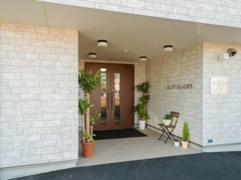 「はっぴーらいふ茨木」のエントランス。観葉植物をエントランス前に設置し、フラットな段差である。