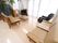 談話室には観葉植物が置かれている。テレビやテーブル、椅子も置かれている。黒いマッサージチェアもある。