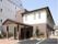 白と茶色のオシャレな外観をもつ施設である。玄関前には長い屋根が設置されている。玄関の横に植物が植えられている。