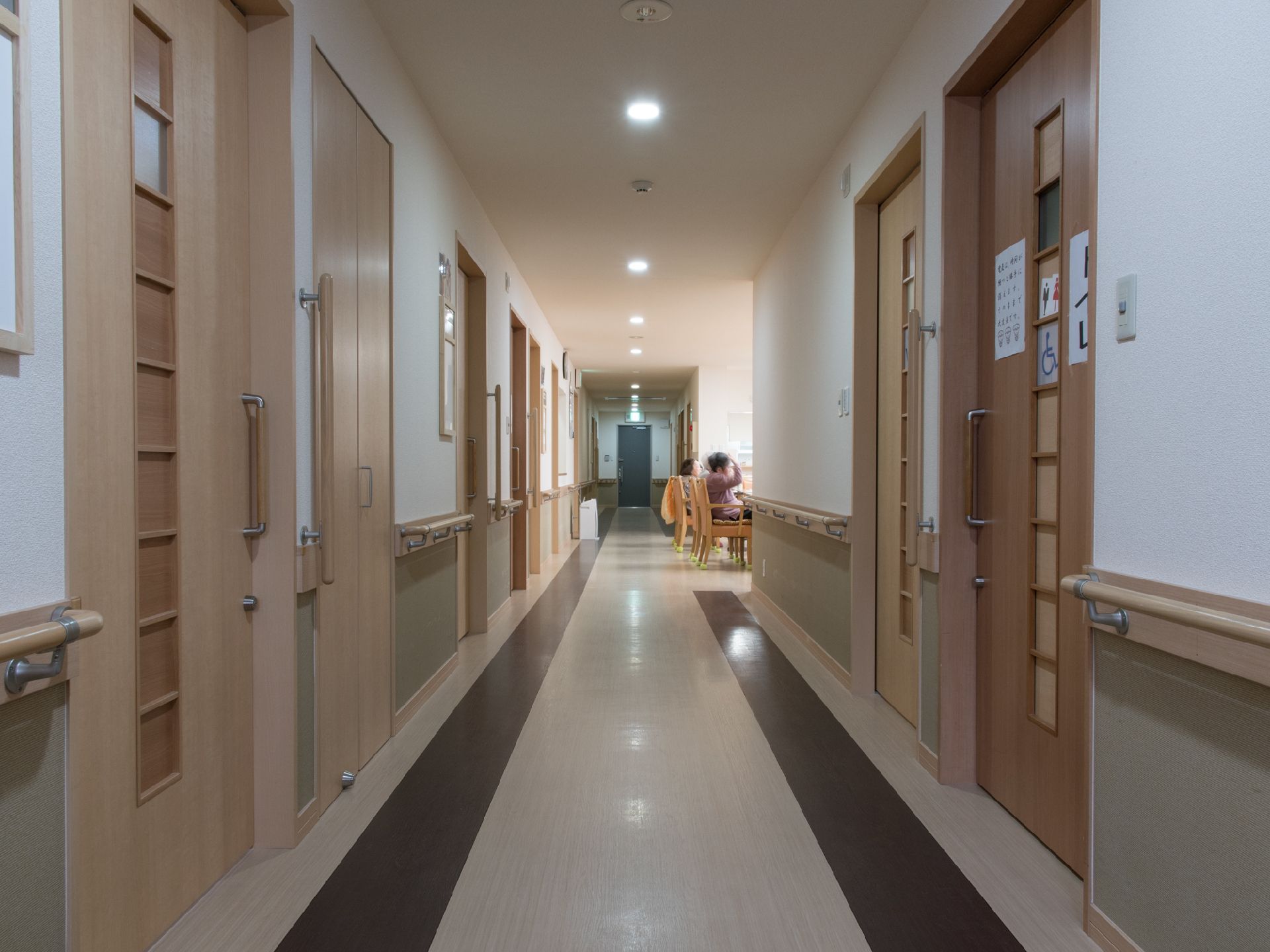 廊下はツートンカラーで塗り分けられている。居室の間にトイレと物入れが設置されている。また、くつろぎスペースもあって、利用者が自由に使える。