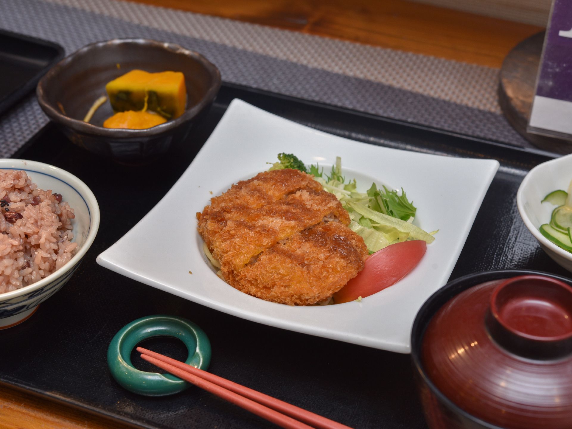 食事の様子である。この日の献立はメンチカツになっている。副菜や器の彩りとも相性が良く、食欲をそそる。