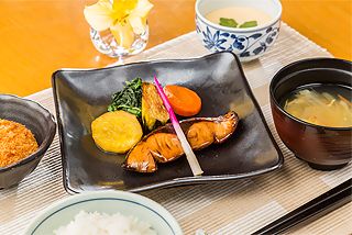 葉生姜を添えた魚の煮物と茶碗蒸し、ご飯と味噌汁の付いたメニュー