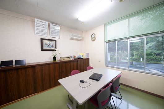 テーブルと椅子が置かれ、広いスペースが確保されている共有スペース