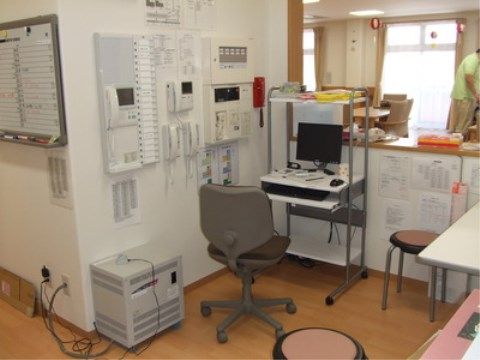 インターホンや赤い緊急通報電話が壁に設置されたセキュリティー室
