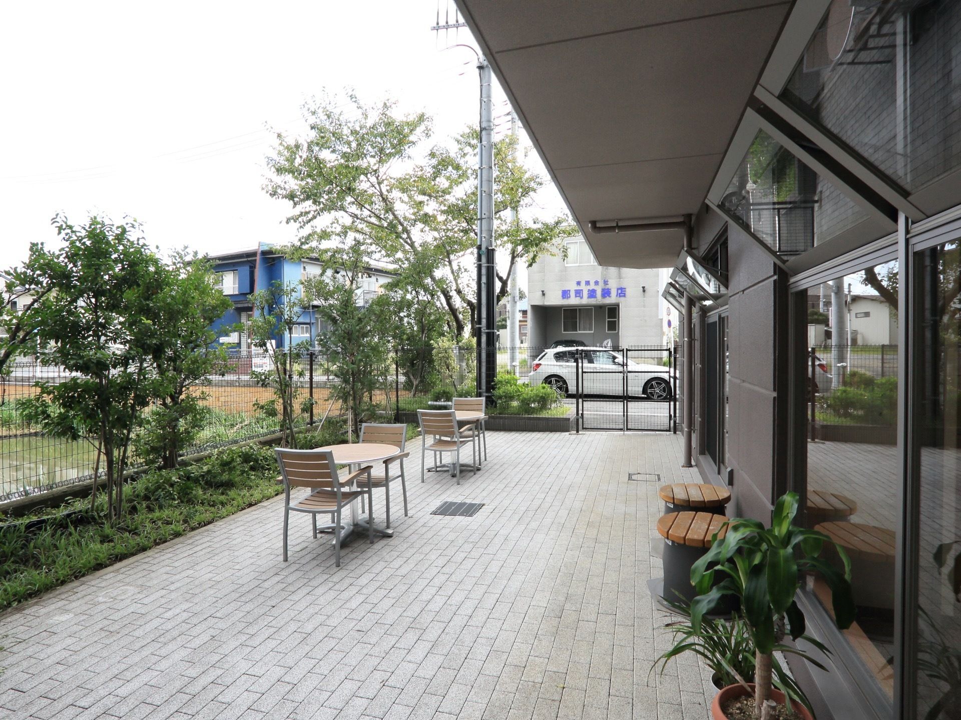 施設には庭があり、椅子とテーブルのセットが２つ置かれている。緑が各所にあり、景色をお楽しみいただける。