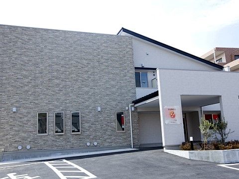エントランス前に屋根が造られたツートーンカラーの建物