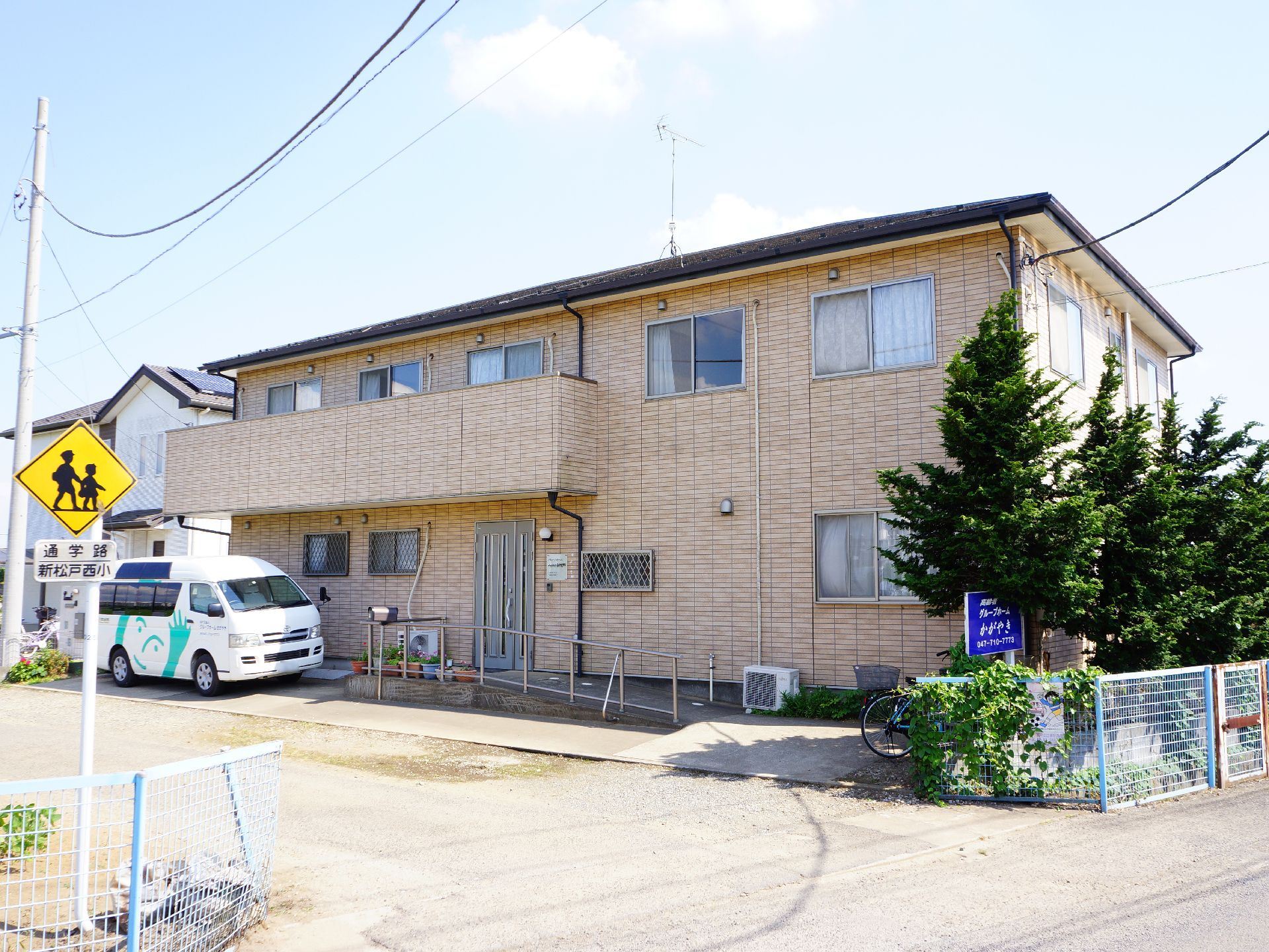 施設はクリーム色の建物で、2階建てとなっている。施設の前には広い道があり、近くの小学校の通学路となっている。