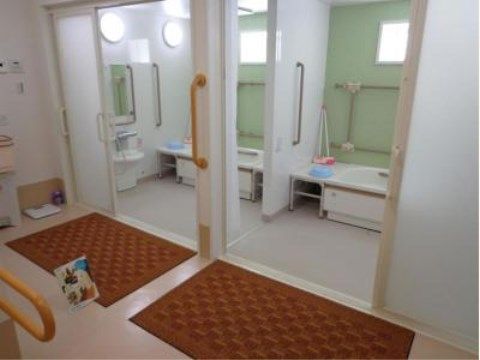 グランドライフ堺Ⅱ番館の浴室。転倒防止の手すりや専用床材を使用し、緊急時のナースコールを設置した安心の浴室となっております。