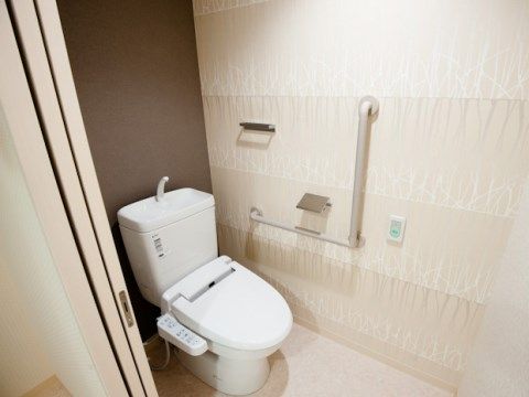 「mottoたくま宿」の居室・トイレ。逆L字型の介助手すりを設置しており、立ち上がり時の下半身を支える。