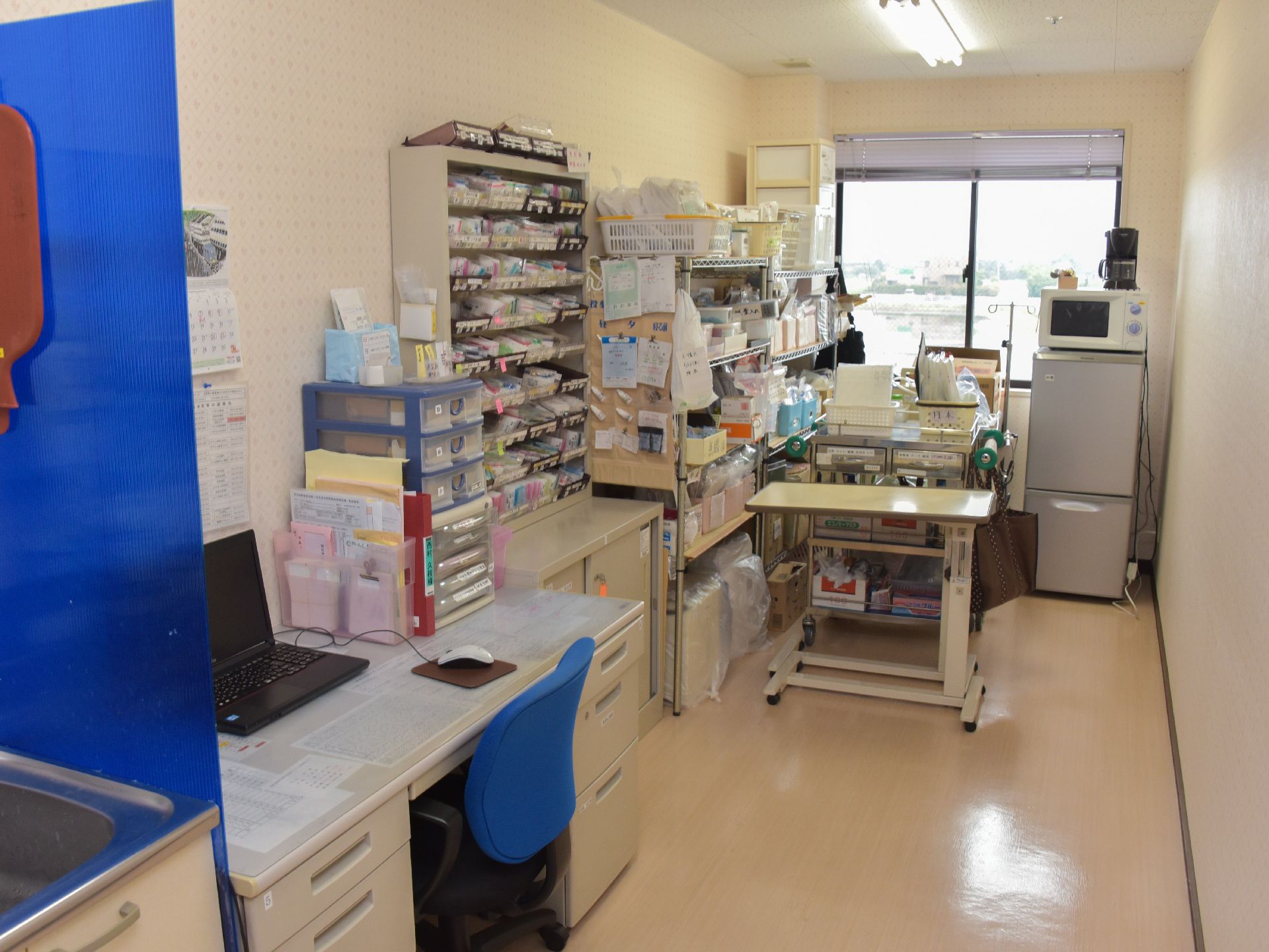 利用者の健康を管理するために必要なものが揃った部屋。冷蔵庫や電子レンジ、水枕や薬、パソコンなどがおかれている。