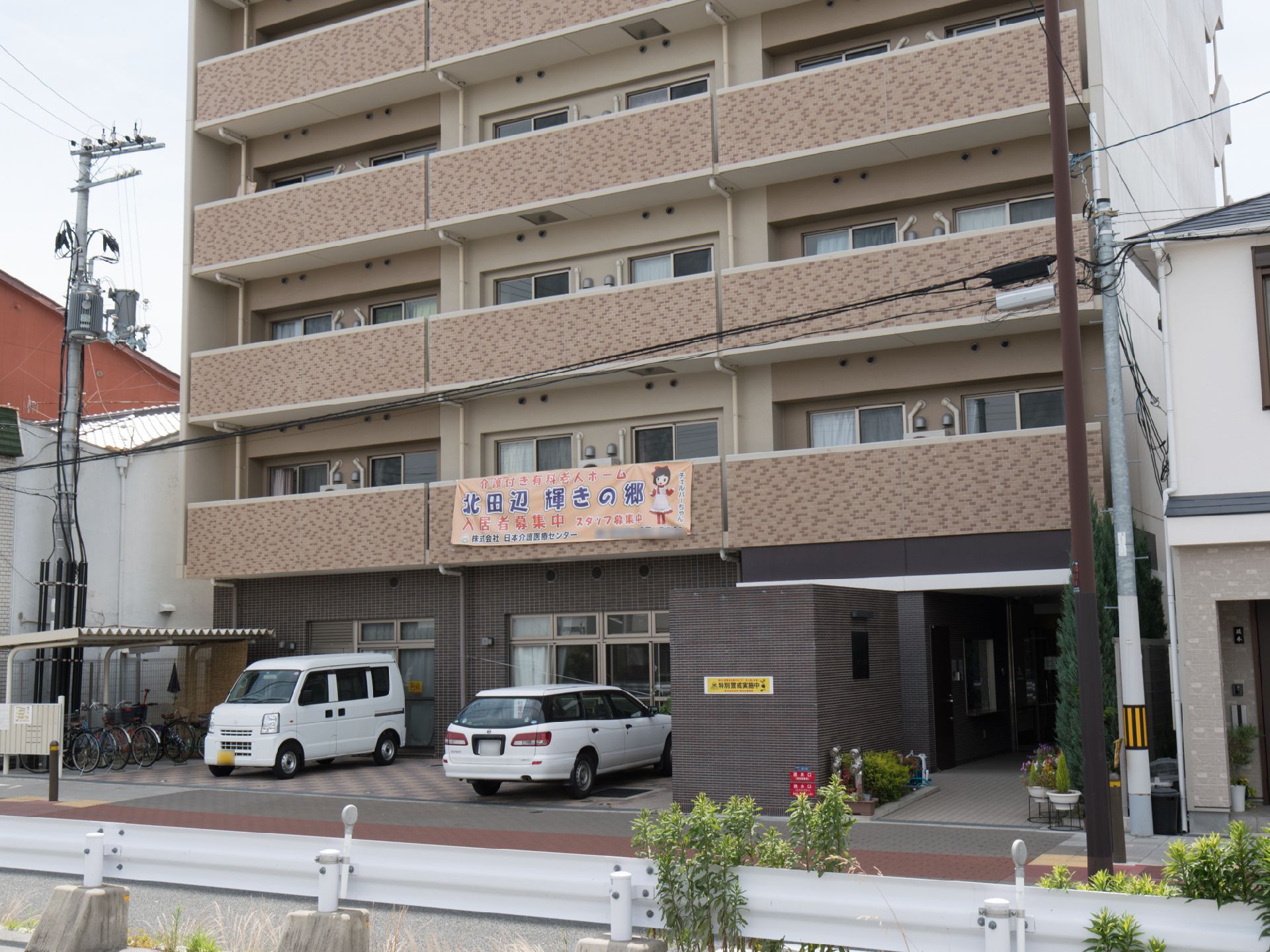 全体的に茶色の外観の施設で、ベランダはフェンスで半分ほど目隠しがある。駐輪場、駐車場が完備である。玄関前にプランターが多数ある。