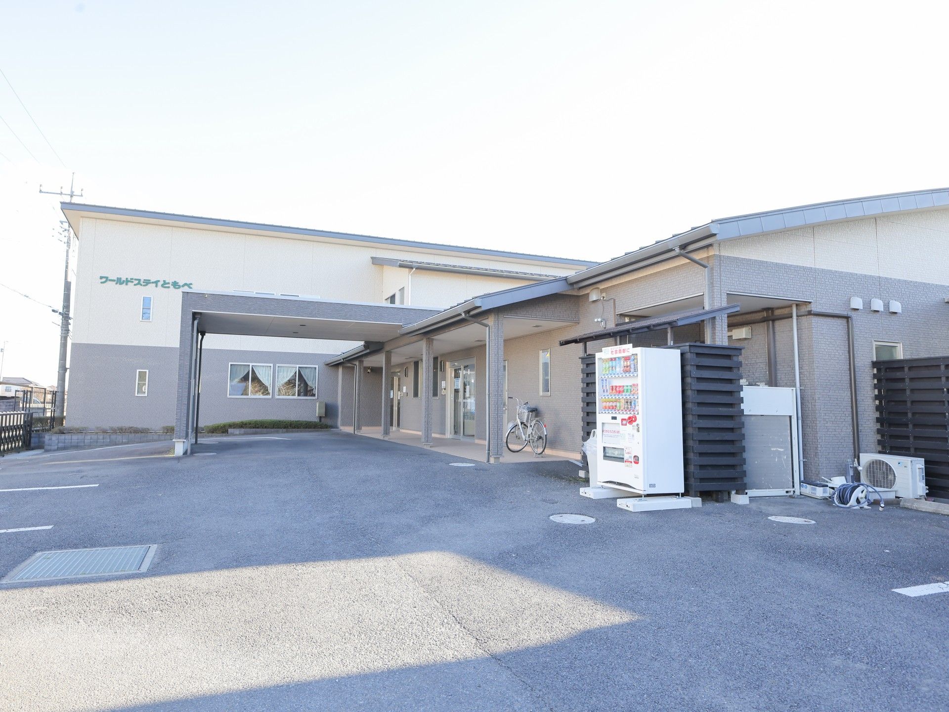 自転車と自動販売機のある建物前