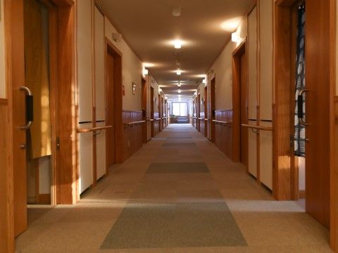 「フェリスヴィラ東茨戸」の廊下。車椅子2台がすれ違えるほど広く、安心して移動ができるようフラットで証明が明るい。