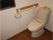 まつの木の家の廊下。どなた様でもお使いいただける共用トイレとなっております。ナースコールが設置されております。