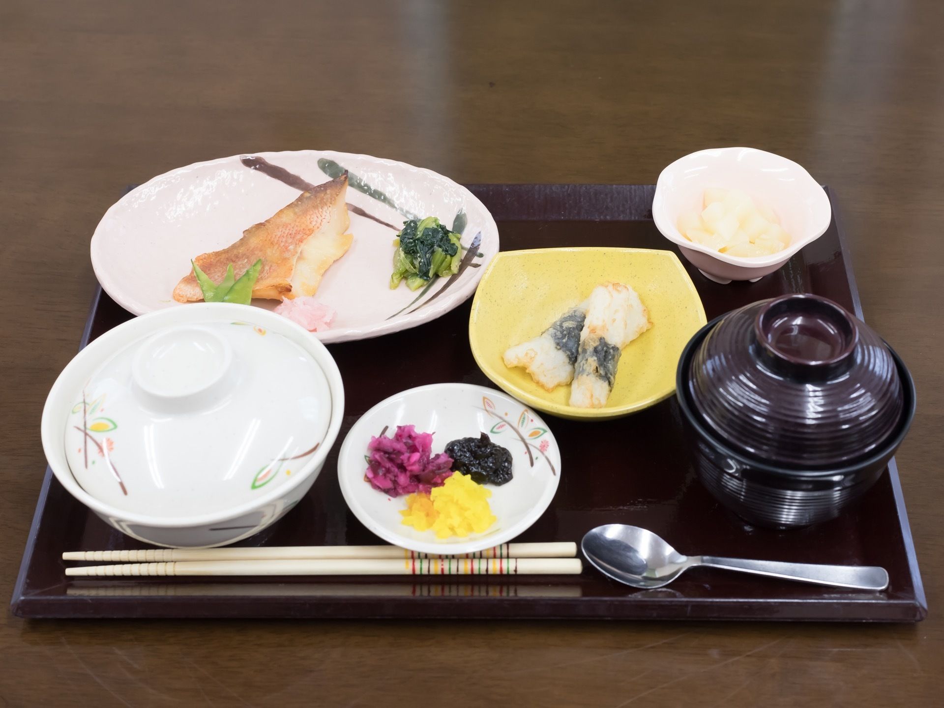 栄養バランスが考えられた、野菜も使われている食事を提供している。トレーにのせており、箸のほかにスプーンも添えられている。