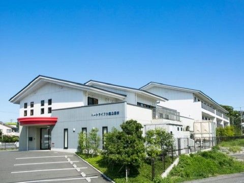 「プレミアムハートライフ小鹿公園前」の外観。4階建ての白色壁が目立つ和風な外観をしている。