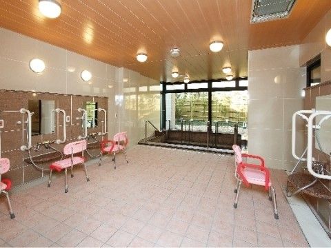 複数のシャワースペースに、手すりやシャワーチェアが設置されている広々とした浴室
