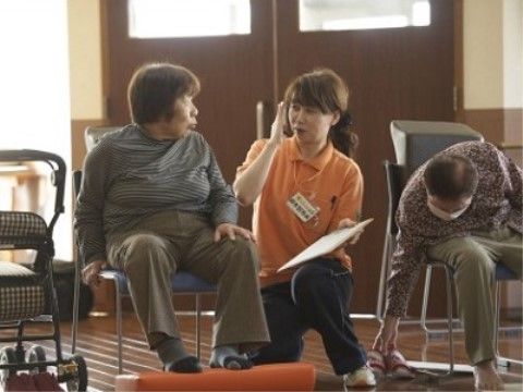 女性スタッフと会話をしている、椅子に座った入居者様の女性