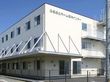 「ふるさとホーム厚木インター」の施設外観。鉄骨造３階建ての大きな白い建物が目印。