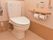 洋式トイレ。トイレットペーパーホルダー件小物置きの上には呼び出しボタンと便器の操作ボタンが設置されている。