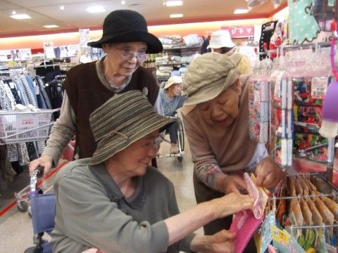 外出先のショップで、品物を見ている帽子をかぶった三名の女性