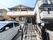 施設の建物は2階建てで、2階にはひさしが備わったベランダがある。物干しざおが掛けられ、洗濯物が干されている。