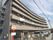 「守山ケアコミュニティそよ風」の外観。6階建てマンション住宅のような外観で、大きく丘の上にそびえ立つ。