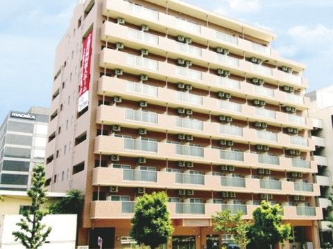 はなことば 新横浜の外観。大きなマンションのような外観。オレンジの柔らかな色使いが優しい印象の外壁。