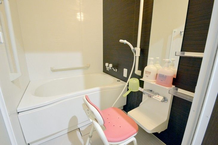 白色とグレイ色の色彩の内装で、壁際には何人かで入れる浴槽が設置してあり、向かい側の壁には洗い場が設けられている。