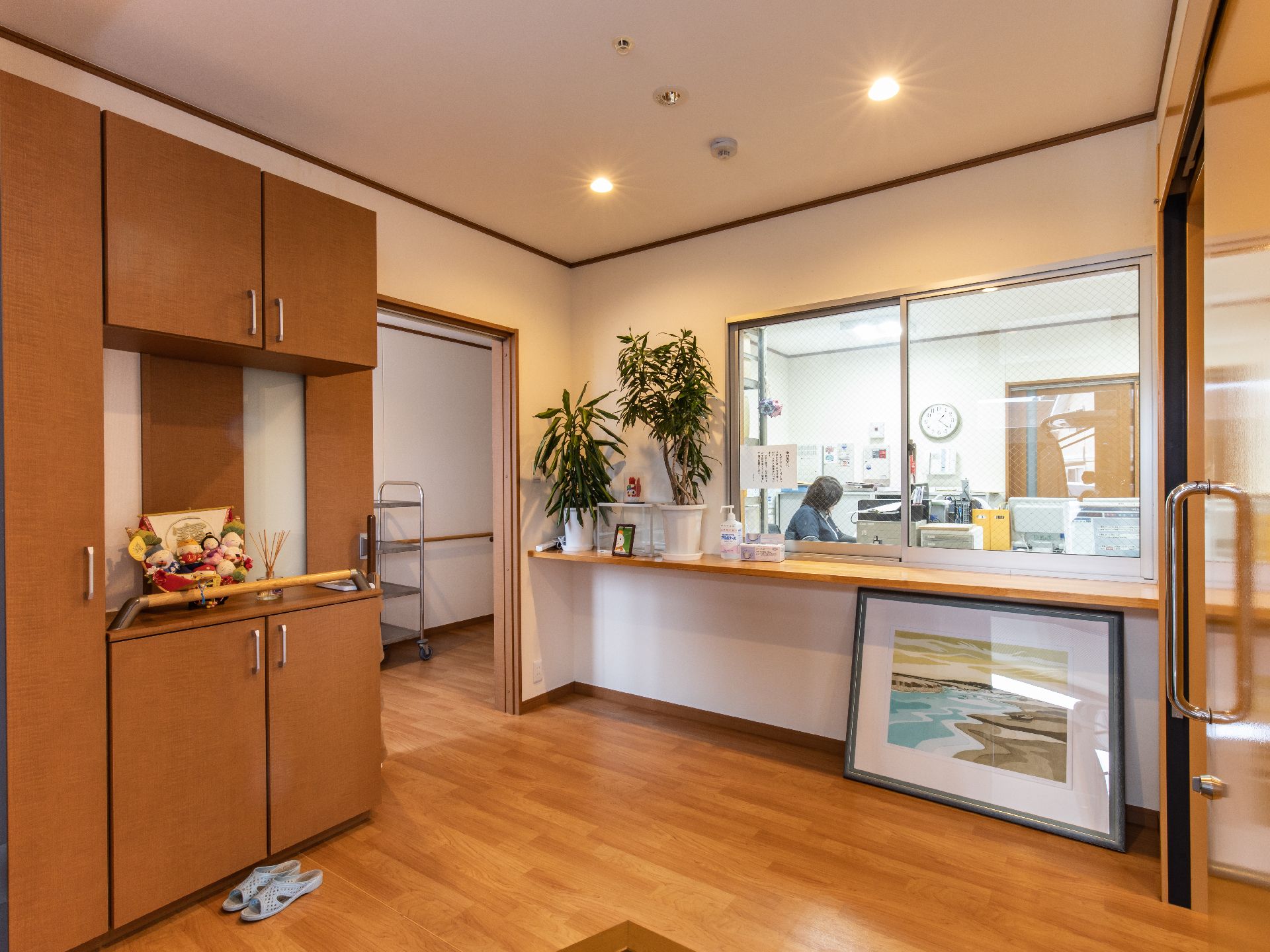 大きな窓からスタッフが見える、装飾を施した施設の玄関