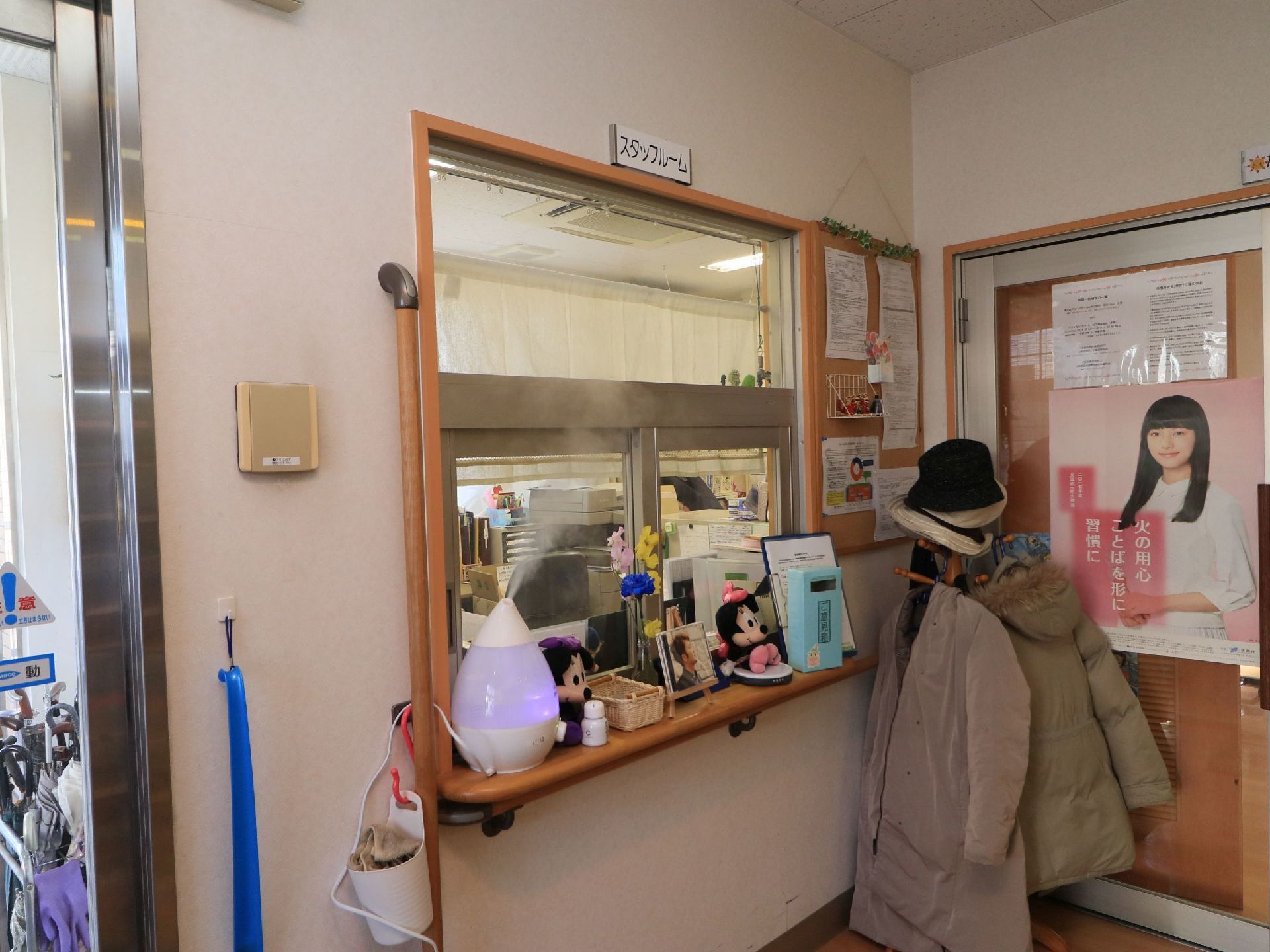 玄関の横にガラス戸のついた受付窓口が設置されている。カウンターの上にはぬいぐるみや加湿器などが置かれている。