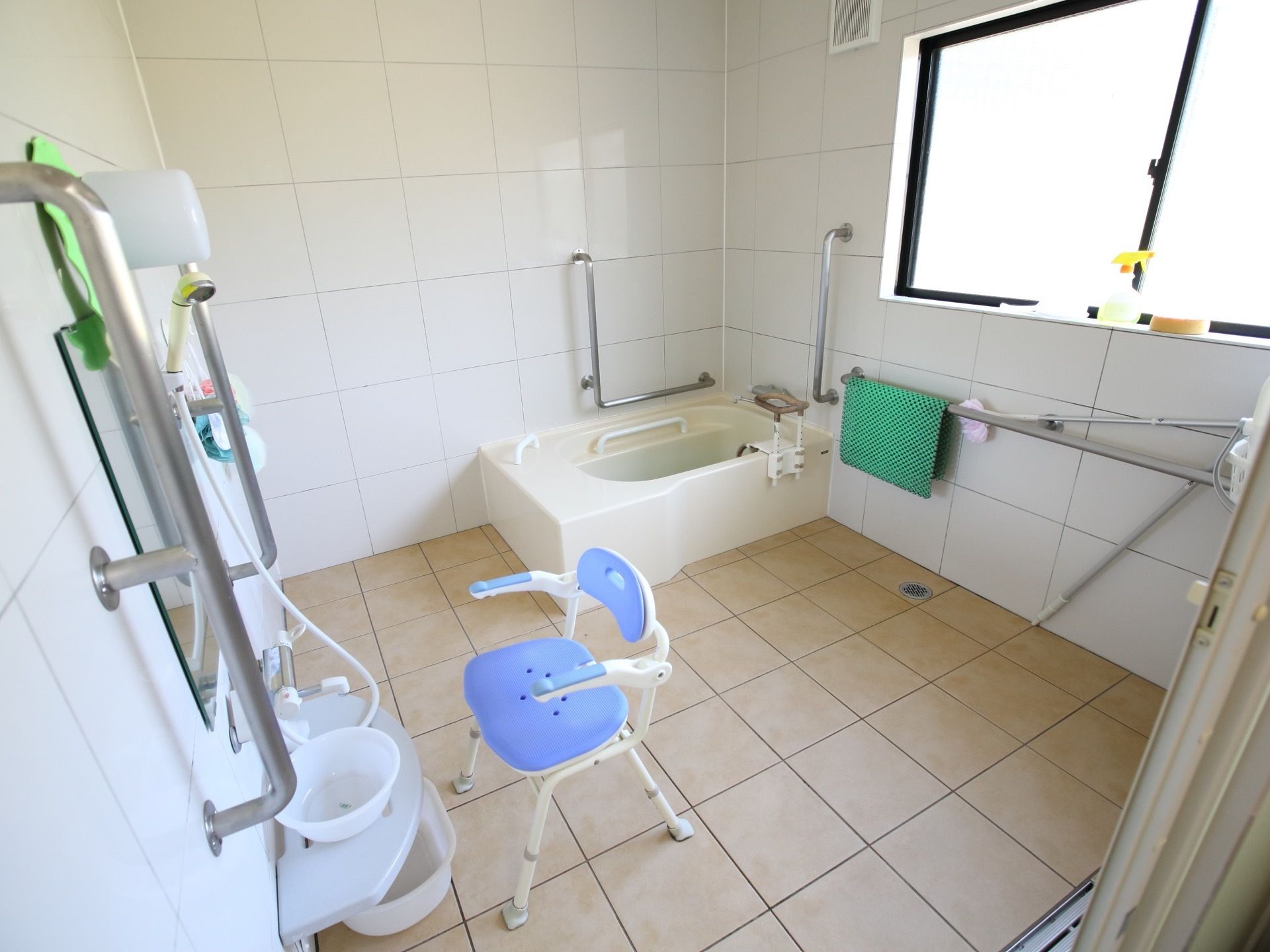 浴室には大きな窓があり、段差のない広々とした空間である。手すりが随所に備わっており、シャワーチェアが完備されている。