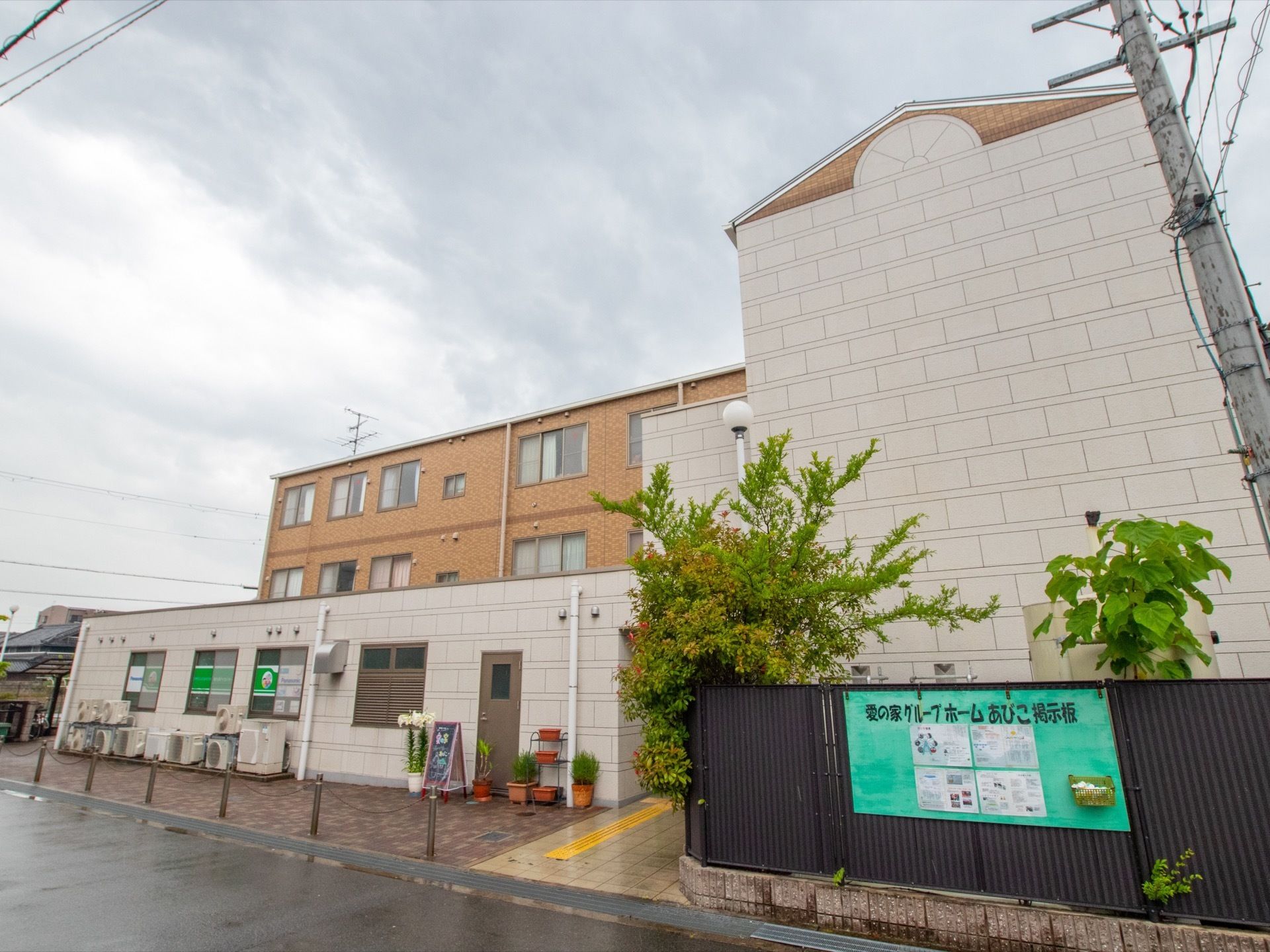 施設は白色と茶色の建物である。周りには高さがある黒いフェンスで囲まれており、そこには施設専用の掲示板が付けられている。