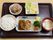 黒い淵で茶色のお盆の上に食事が盛り付けてある。メインのひじきが入ったハンバーグ、マカロニを使ったサラダなどが彩もよく、のっています。