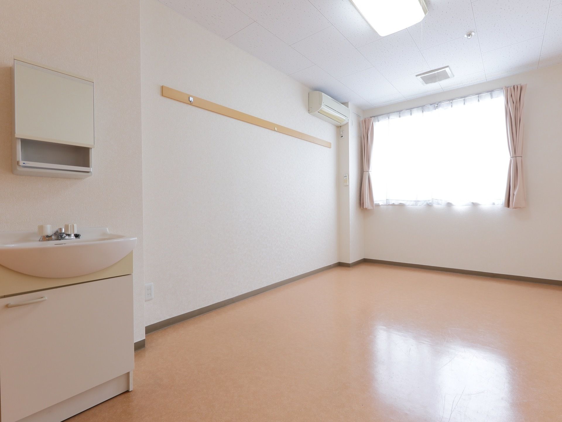 洗面所がある。エアコンが設置されている。とても広いお部屋である。床はフラットなので安全に歩行できる。