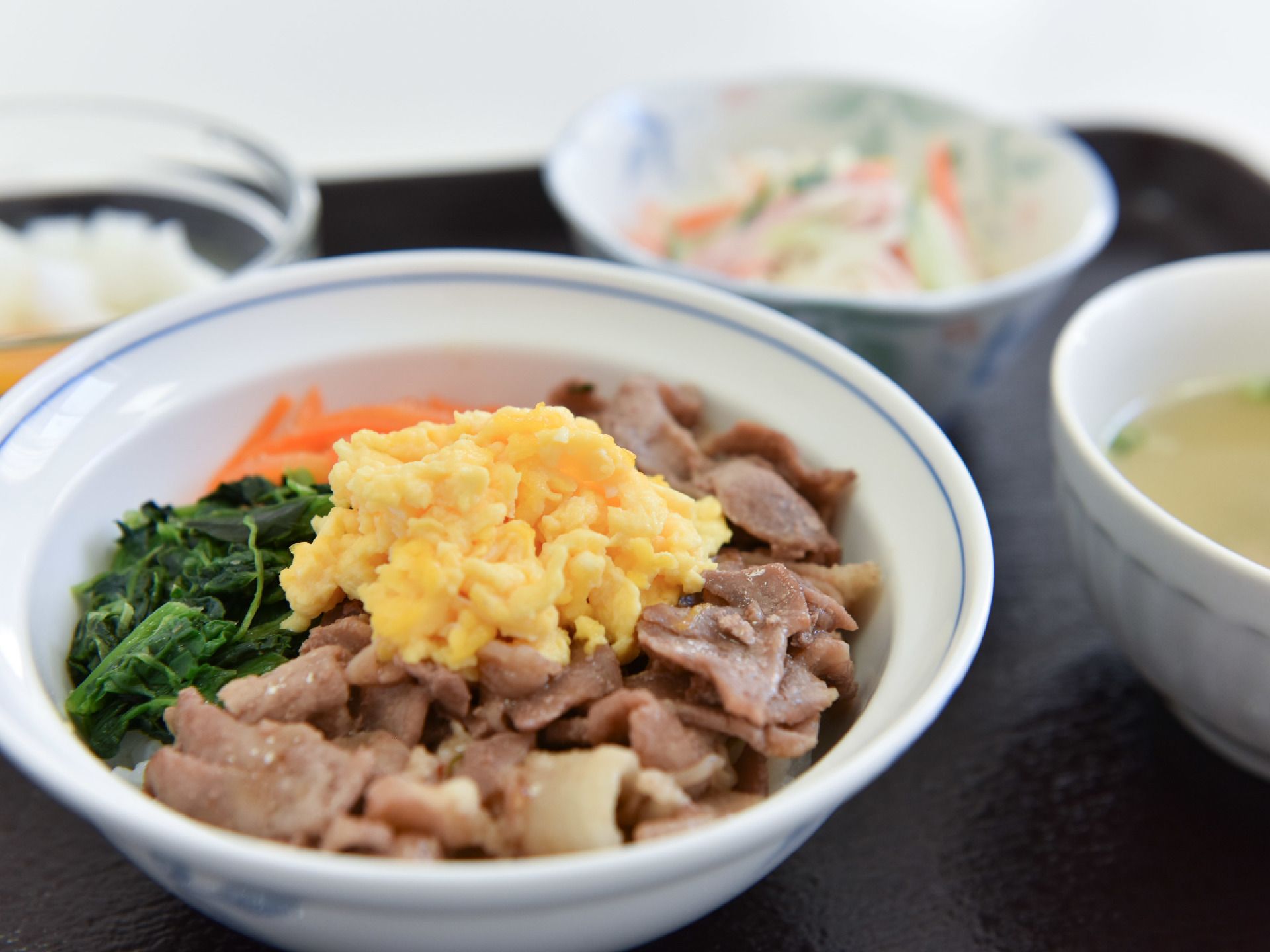 肉、野菜、ご飯とタンパク質、食物繊維などのバランスのとれた食事である。野菜、汁物、ご飯と彩のある食事である。