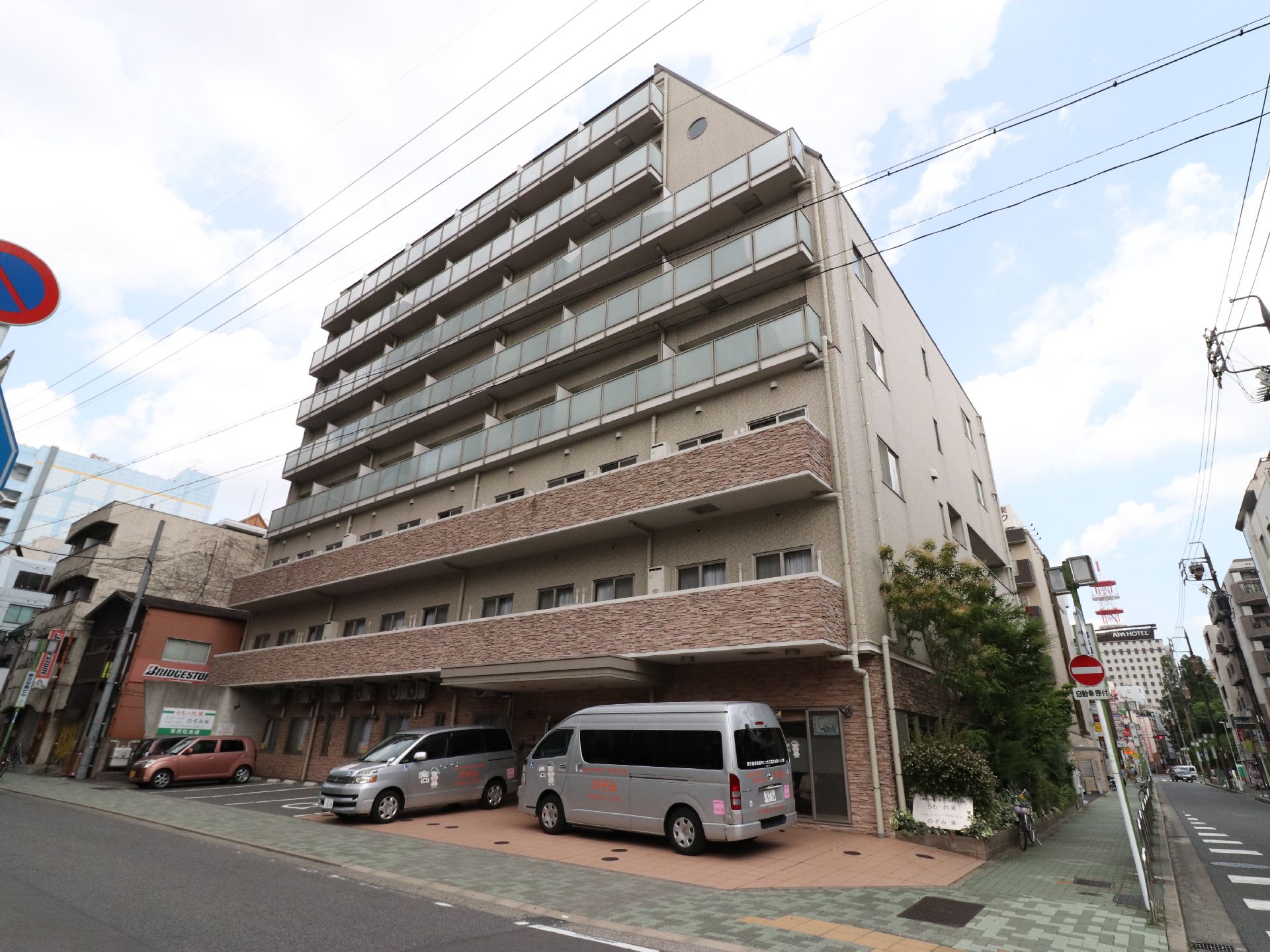 施設のフロント側には、駐車スペースがある。また玄関前に車を横付けすることも可能である。規則正しく窓とベランダが並ぶ外観をしている。