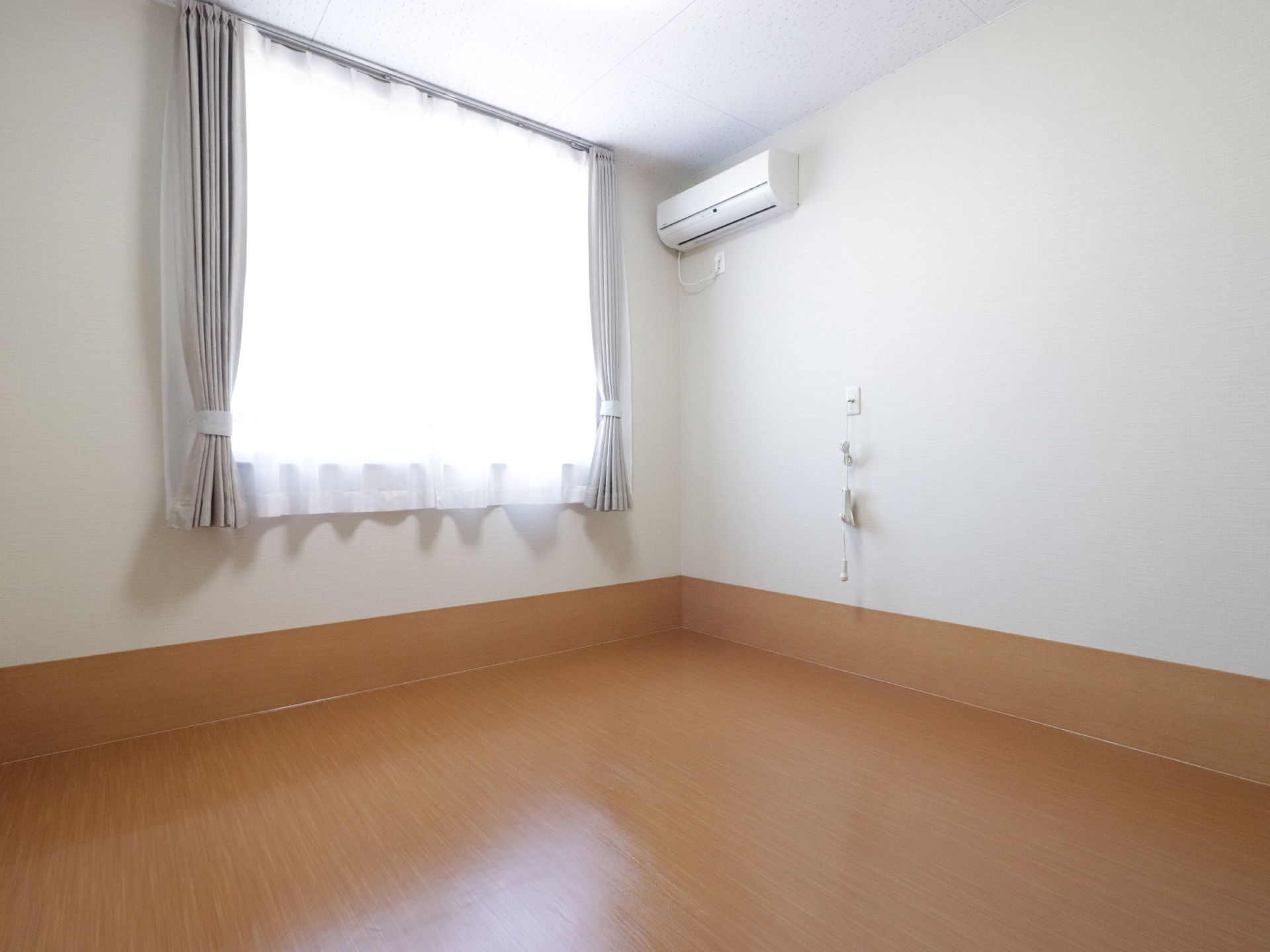 腰高窓がある部屋は、床が板張りの洋間になっている。室温調節も簡単にできるようエアコンも完備している。