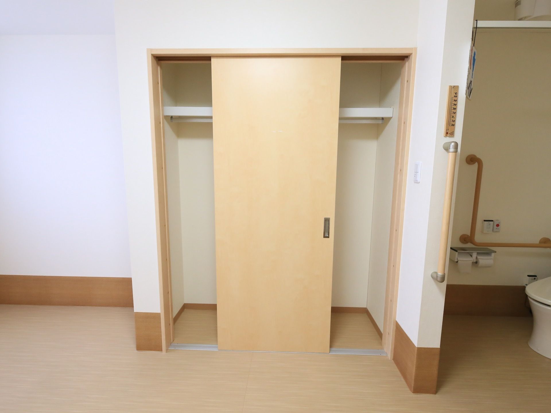 居室の一角に、引き戸のクローゼットがある。収納スペースには棚板が設けられており、上下2段に分かれている。