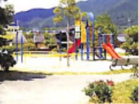 緑の山をバックに開放的な場所にある公園。複合遊具があり、滑り台やうんていなど、数種の遊具で遊ぶことができる。