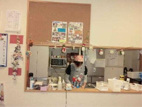 食堂に設けられた対面式キッチンで調理をしているスタッフ