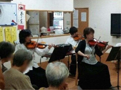 ３人の女性バイオリニストの演奏に聞き入っている入居者の皆様