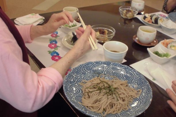 ざるそばと太巻き寿司を食べる様子