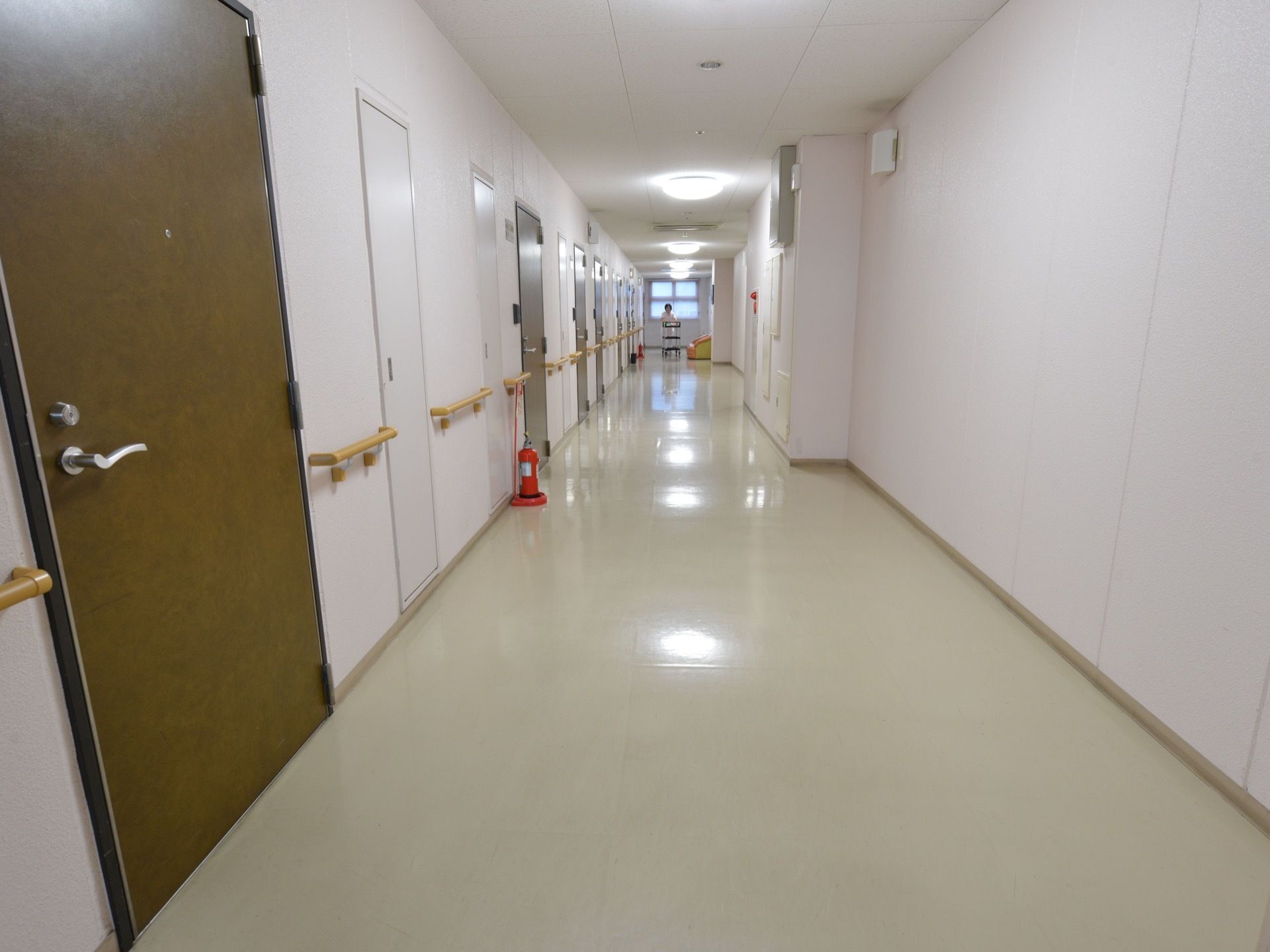 白を基調とした通路。壁には手すりが設置されている。通路の幅は広く、車椅子や歩行器をご利用の方も通りやすい。