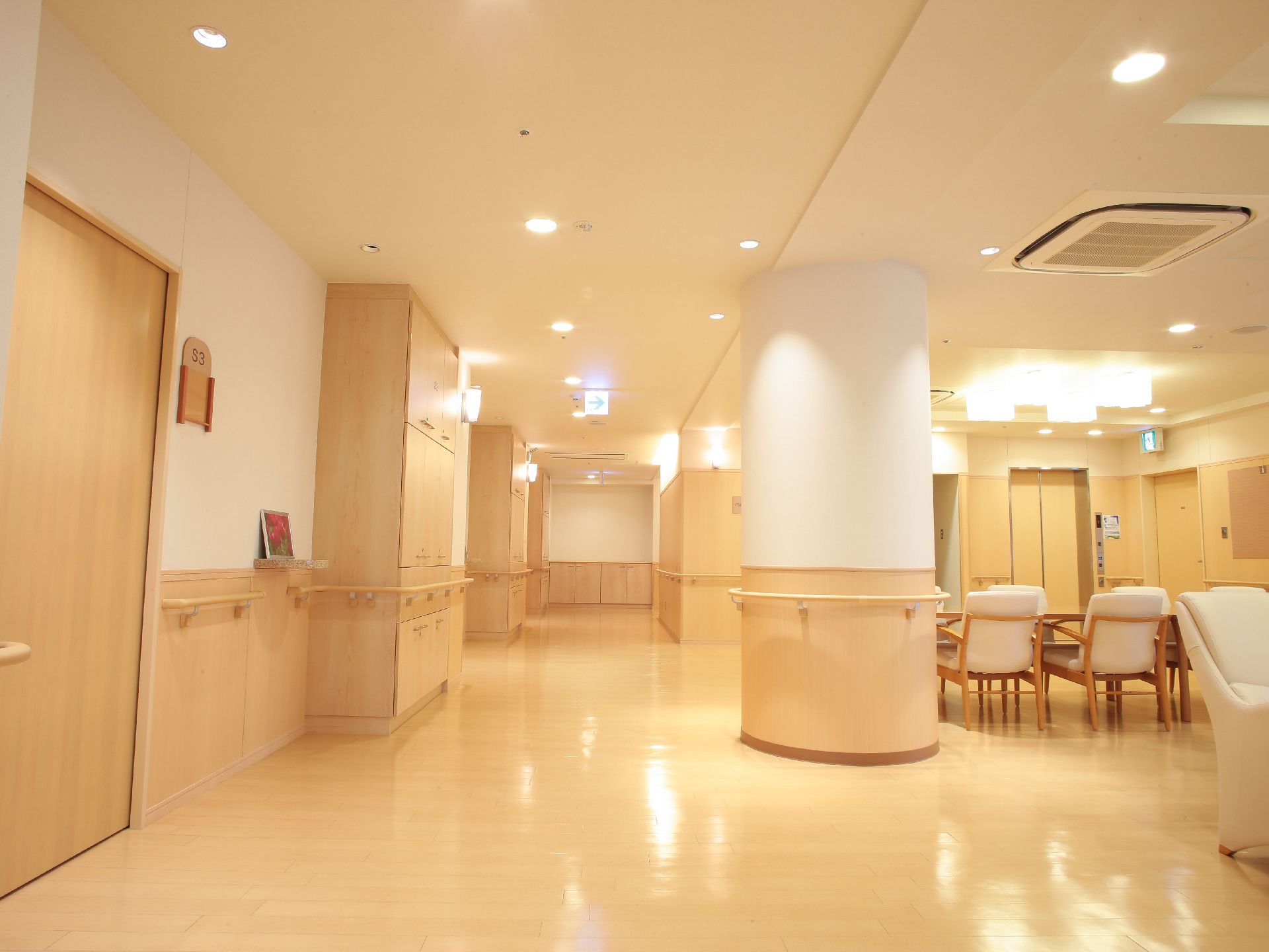 木目を基調とした内装で、中央に大きな円柱の柱がある。通路とエレベーターに隣接したスペースでテーブルと椅子が並べてある。