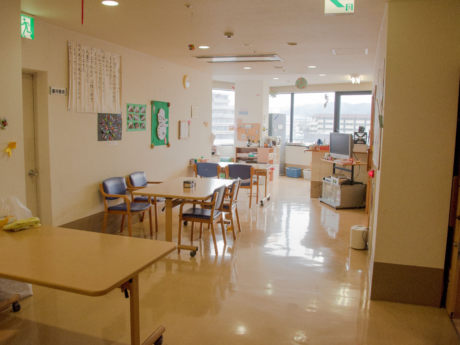 大きめの窓からは明るい光が差し込んでいる。左手の壁によせて木製のテーブルが置かれ椅子も数脚用意されている。