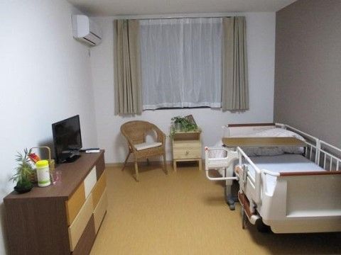 介護用ベッドと、衣装棚の上にはテレビが設置された寝室