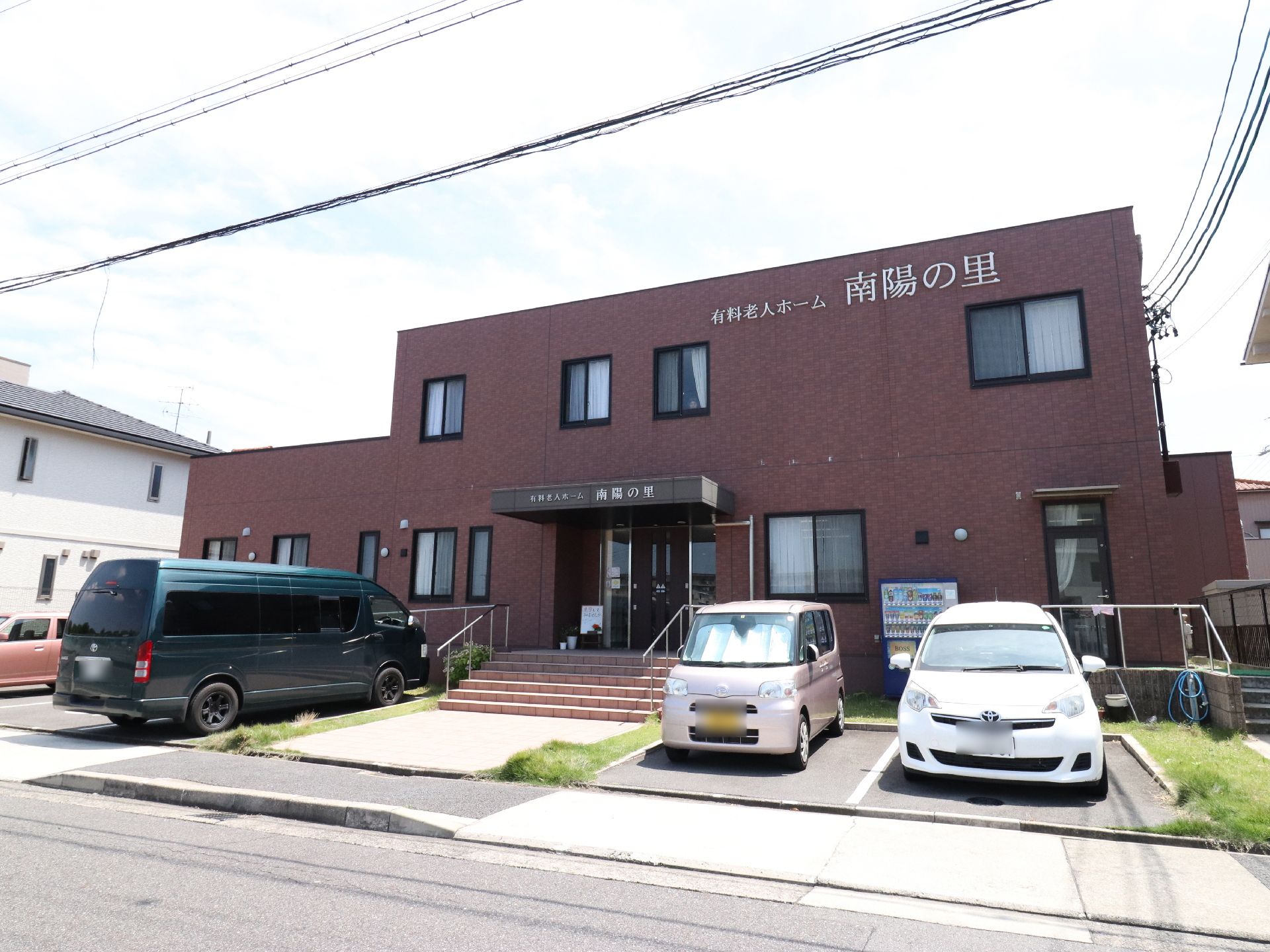 老人ホームの建物には、大きく名前が取り付けられているので、誰にでも分かりやすくなっている。外には自動販売機も設置されている。