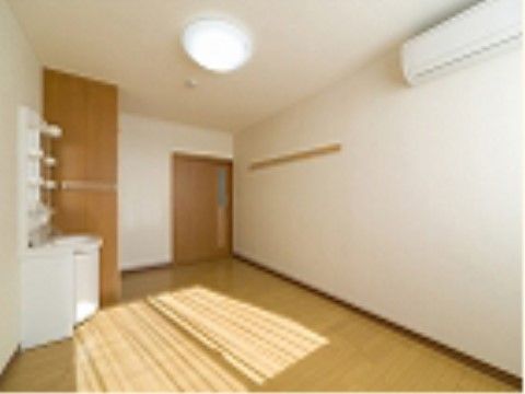 エアコンと洗面台の設備があり、窓から光の入る明るい室内