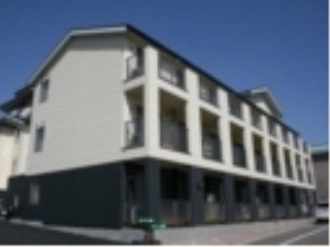 新しい３階建ての建物で、外壁の色は１階部分が黒、２，３階が白い。敷地前から歩道までフラットに繋がっている。